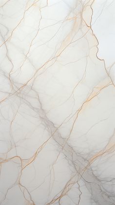 an image of marble textured with gold lines on it's surface in white and beige