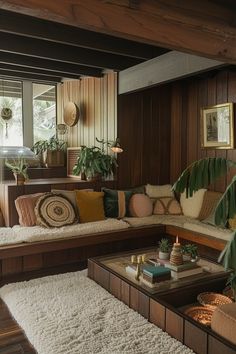 a living room filled with lots of furniture and plants