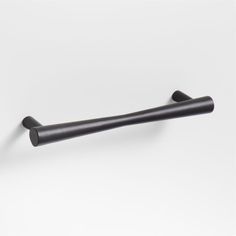 a black handle on a white wall