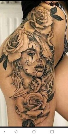 a woman's back with roses on it, and the bottom half of her thigh