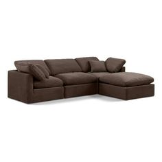 a brown sectional couch with pillows on it