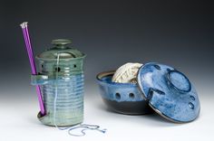 two bowls with yarn in them next to a canister