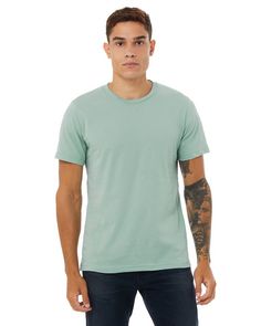 a man with tattoos standing in front of a white background wearing a green t - shirt