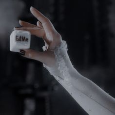 a woman's hand holding an electronic device with the word emme written on it