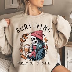 Surviving Purely Out Of Spite, Staying Alive Coffee Sweatshirt, Trendy Sweatshirt, Funny Skeleton Sweatshirt, Halloween Vintage Sweater for Women Stay Oversized Crewneck We add color and size charts to each for references so please make sure that you are selecting carefully. Once an order is received it goes into production and we are unable to cancel orders. ABOUT: :) This pre-shrunk, classic fit sweatshirt is made with air-jet spun yarn for a soft feel and reduced pilling. :) Pre-shrunk :) Cla Oversized Skull Print T-shirt For Fall, Fall Skull Print Crew Neck Sweater, Fall Oversized T-shirt With Skull Print, Fall Skull Print Long Sleeve T-shirt, Long Sleeve Skull Print T-shirt For Fall, Skeleton Sweatshirt, Photo Care, Sweatshirt Trendy, Coffee Sweatshirt