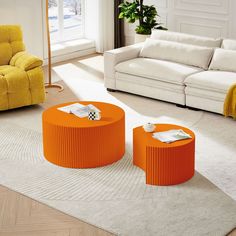 an orange coffee table sitting on top of a rug in front of a white couch