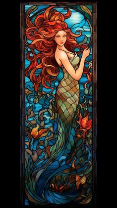 a stained glass window with a mermaid holding a fish in it's hand and looking at the viewer