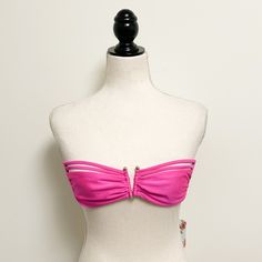 Swimwear Brand: Luli Fama Size: Xs (**Please See Photos For Approximate Measurements As Bathing Suits Tend To Runs Small**) Style: “Muy Caliente” Pink Bandeau Bikini Top. Strap Accents With A Gold Tone “V” Center. Back Tie Closure. No Underwire And No Padding In Cups. Hand Wash Garment Care. Condition: New With Tag But Please Be Advised As There Is A Tiny Pull On The Front Of One Cup. Comes From A Smoke Free Home. Please Feel Free To Ask Any Questions Before Purchase. I Typically Ship Within 24 Hours But Please Be Advised That I Don’t Ship On Saturdays Or Sundays. Thank You For Understanding! Pink Sleeveless Tube Top For Beach Season, Pink Summer Tube Top For Beach, Pink Summer Tube Top For The Beach, Pink Tube Top For Beach Party Season, Pink Summer Tube Top, Pink Tube Top For Poolside And Beach Season, Pink Bandeau Tube Top For Pool, Pink Bandeau Swimwear For Beach, Pink Bandeau Tube Top For The Pool