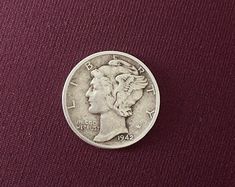 an image of a coin on a purple cloth