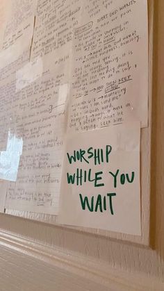 a bulletin board with writing on it that says worship, while you wait written in green