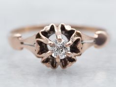 This is a buttercup mounting, with a layer of ripples surrounding the diamond. This polished, solitaire ring is rose gold and set with a small sweet old mine-cut diamond. The stone has wonderful glitter and light shines deep within the stone. This versatile style suits well as an engagement ring, sweetheart gift, or even a birthstone ring for that special sweet sixteen!Metal: 10K Antique Rose GoldGem: Old Mine Cut Diamond .11 Carats, K in Color, SI1 in ClarityGem Measurements: 3.1 mm, Round Ring Size: 5.75Marks: “10K” Stamped on the inside band Buttercup Ring, Old Mine Cut Diamond, April Birthstone, Antique Roses, Round Rings, Sweet Sixteen, Birthstone Ring, Versatile Style, Pearl Pendant