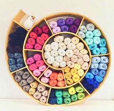 a basket filled with lots of different colored doughnuts on top of a table