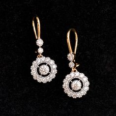 A stunning diamond dangle earrings are a perfect pair for your big day! With over a quarter carat of diamonds, these earrings sport a 0.10ct diamond in the center with a scalloped diamond halo which dangles beautifully from 2 diamonds! The ear wire is comfortable and can be locked for a secure fit! * Diamond Wt. : 0.85 Cts * Color-Clarity Grade : H-I, Vs-Si * Gold - 14K, 3 gms solid gold These earrings come in a lovely gift box with EGL certification. Find us on Instagram for exquisite designs: Fine Jewelry Bridal Drop Earrings With Brilliant Cut, Dazzling Diamond Cluster Drop Earrings, Dazzling Diamond Drop Earrings, Elegant Diamond Drop Earrings, Elegant Drop Diamond Earrings, Exquisite Bridal Drop Earrings With Diamond Accents, Luxury Drop Earrings With Single Cut Diamonds, Fine Jewelry Dangle Earrings With Single Cut Diamonds, Dazzling Diamond Dangle Earrings With Accents