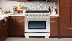 a white stove top oven sitting inside of a kitchen next to wooden cupboards and counter tops