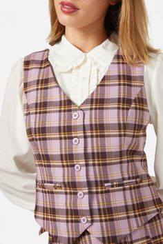 Step into the delightful realm of retro-inspired panache with the Check Vest from Princess Highway. This fetching piece, swathed in a dreamy lilac hue, offers versatility that's as endless as your imagination. Wear it over a blouse or knit top for a dose of layered charm, or dare to wear it solo for a standout statement that's as playful as it is poised. The deep V neckline and pointed hem shaping carve out an enchanting silhouette, while the sweet front pocket feature adds a touch of whimsy, perfect for stashing a lucky penny or a piece of candy for later. Secured with a front button closure and equipped with a back adjustable tab, it ensures a perfectly cinched fit that flatters. Woven from a blend of polyester, viscose, and elastane, this vest is as comfortable as it is captivating. Whe Sabrina Spellman Style, Check Vest, Princess Highway, Plaid Vest, Goth Dress, Tartan Dress, Fashion Catalogue, Knitted Coat, Kids Coats