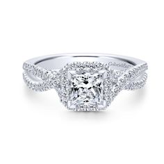 an engagement ring with a princess cut diamond surrounded by pave diamonds