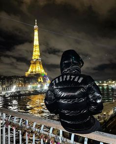 a person looking at the eiffel tower in paris