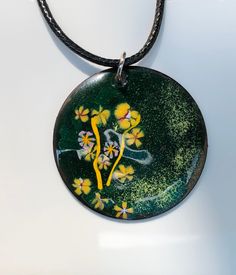 "This is a 1 1/2\" copper enamel pendant that I created adding a base coat of green and adding yellow, lavender and a bit of white. This will arrive with a waxed leather cord of approximately 20-22\", but feel free to add any chain or choker of  your choice. Thanks for looking!" Green Jewelry With Black Enamel For Gift, Green Jewelry With Black Enamel As A Gift, Green Flower Pendant Necklace With Large Pendant, Green Necklace With Large Flower Pendant, Green Necklace With Large Medallion Pendant, Green Enamel Pendant Necklace, Hand Painted Enamel Round Pendant Necklace, Artistic Green Round Pendant Necklace, Green Hand Painted Necklace For Gift