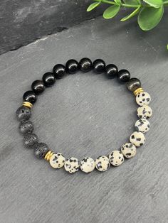 Do you like aromatherapy? This bracelet is perfect for you. Simply add 2 to 3 drops of your favorite essential oil and feel the benefits throughout your day. Description of this bracelet: - Dalmatian Jasper natural stone beads 8mm - Natural black obsidian stone beads 8mm - Waxed natural lava stone beads 8mm - 6mm gold-plated stainless steel rings - Top quality Beadalon (USA) elastic. Bracelet length: 5.5 inches (Very very small) to 9 inches (Very very very large) If you do not know your wrist di Hypoallergenic Black Beaded Bracelets For Healing, Casual Black Beaded Bracelets With Natural Stones, Everyday Black Hypoallergenic Bracelets, Black Hypoallergenic Everyday Bracelets, Hypoallergenic Black Beaded Bracelets, Handmade Black Beaded Bracelets, Black Round Beads Bracelets Holistic Style, Black Hypoallergenic Beaded Bracelets, Everyday Hypoallergenic Black Beaded Bracelets