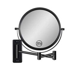 a wall mounted mirror with a light on it's arm and black metal frame