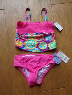 My Auction… You are looking at a cute BEACH NATIVE brand NEW WITH TAGS girl's youth size 6 two-piece pink tankini swimsuit set.  This swimsuit style # is 5004P has a peace sign and tie dye pattern (see pictures).  It is NEW WITH TAGS, retails for $20 plus tax and shipping (if applicable), and the original tags are attached.  All items come from a pet and smoke free home and are free from holes or stains unless noted. If you have any questions please ask before bidding. Please check out my other Native Brand, Pink Tankini, Tie Dye Pattern, Tankini Swimsuit, 2 Piece Swimsuits, Swimsuit Set, Tankini Swimsuits, Swimsuit Fashion, Tie Dye Patterns