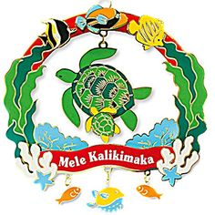 a turtle and fish hanging from the side of a sign that says mele kalikamaka