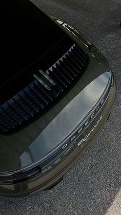 the front end of a green sports car