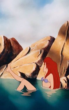 the little mermaid is sitting in the water