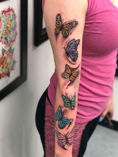 a woman's arm with butterflies on it