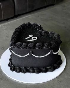 a black and white cake sitting on top of a plate