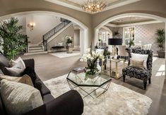 a living room filled with furniture and a chandelier