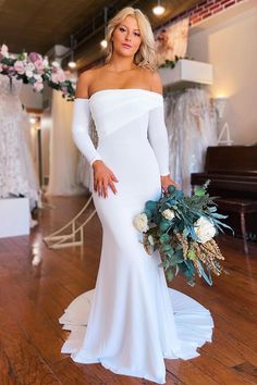 a woman in a white dress holding a bouquet