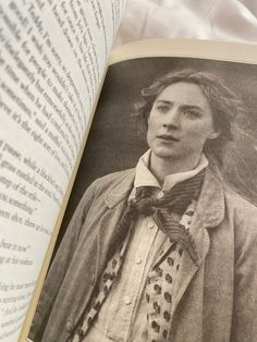 an open book with black and white photograph of a woman wearing a bow tie on it