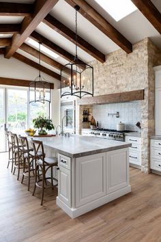 a large kitchen with an island in the middle and lots of counter space on one side