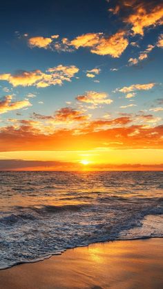 the sun is setting over the ocean with clouds in the sky and waves on the beach