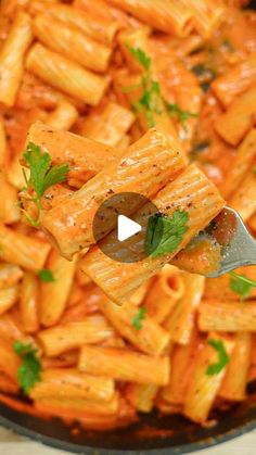 a pan full of pasta with parsley on top