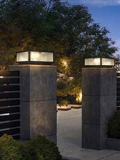 two concrete pillars with lights on top of them