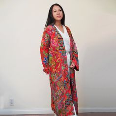 This is a washable printed batik robe/ kimono handmade by artisans, thick duster and home jacket. Because of the upcycled material and handmade nature of this item, each batik quilt kimono is not alike. The print will be of slightly different pattern and color but in variation of black, blue, pink, purple, green mix pattern. This thick quilted patchwork robe is handmade by artisans in Java using upcycled printed fabric from leftover fabric sourced from clothing manufacturer. This jacket is NOT r Bohemian Kimono With Natural Dye And Relaxed Fit, Bohemian Kimono With Natural Dye, Bohemian Kimono With Natural Dye In Relaxed Fit, Bohemian Long Outerwear With Relaxed Fit, Bohemian Long Relaxed Fit Outerwear, Bohemian Long Sleeve Relaxed Fit Robe, Bohemian Long Sleeve Robe With Relaxed Fit, Bohemian Cotton Kimono With Batik Print, Bohemian Outerwear With Floral Print And Kimono Sleeves