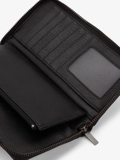 This roomy, yet stylish vegan leather wallet features 14 card slots, 2 bill compartments, and a zipper coin pocket. Complete with zip around closure, this durable wallet will quickly become an everyday staple. FIT + STYLE Zip around wallet. Color: Black Interior: 14 card slots including 1 transparent ID slot, 2 bill compartments, zipper coin pocket Dimensions: 8" x 4" x 1" MATERIALS + CARE 100% Vegan leather exterior 100% Recycled nylon lining Matt & Nat, Recycled Bottles, Black Interior, Card Slots, Zip Around Wallet, Leather Wallet, Vegan Leather, Fitness Fashion, Wallet