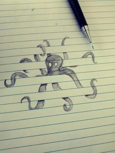 an octopus drawn on lined paper with a pen in front of it and the caption below