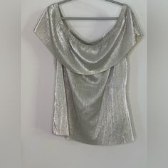 This Is A New With Tag A.N.A. Brand Off-Shoulder Silver Metallic Blouse. This Has A Metallic Foil Look To It And I Think It’s Perfect For A Party Or Holiday Celebration! It’s A Size Xl. Metallic Silver Fitted Top For Night Out, Glamorous Metallic Shimmer Blouse, Chic Silver V-neck Top, Cheap Silver V-neck Top, Chic Metallic V-neck Top, Pink Floral Blouse, Metallic Blouses, Velvet Blouses, Cold Shoulder Blouse