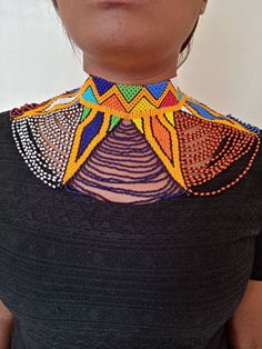 African wedding necklace, Zulu necklace, Beaded shawl necklace, African jewelry, Masai necklace, Bridesmaid necklace, Wedding gift This stunning necklace is superbly crafted with fine beads. The necklace can be worn with any outfit at different occasions and it will absolutely makes you stand out. 100% handmade using fine beads. Closure: ball joint Color: Multicolor 3-5 days delivery via DHL Express The shipping fee is for the first item only and additional necklaces or items ship for free. BROW Bohemian Colorful Beads For Wedding, Multicolor Polished Round Beads Bridal Necklace, Multicolor Bridal Necklace With Polished Round Beads, Wedding Multicolor Beaded Chain Beads, White Beaded Choker For Festivals, Multicolor Beaded Choker For Wedding, Bohemian Beaded Choker Necklace For Wedding, Bohemian Tiny Beads Necklaces For Wedding, Multicolor Beaded Chain Necklace For Wedding