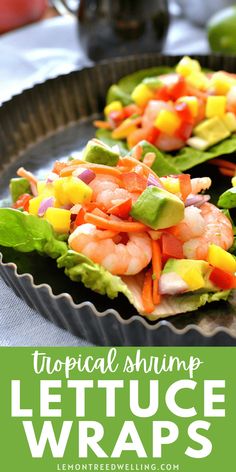 two lettuce wraps filled with shrimp and vegetables on top of a metal pan