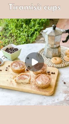 there is a wooden cutting board with pastries on it