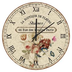 a clock with flowers painted on it and roman numerals around the numbers in french