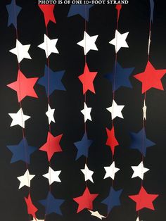 red, white and blue stars hanging from strings on a black background that says photo is one - foot strand