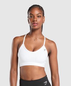 IT'S NOT YOU, IT'S YOUR SPORTS BRA With lightweight, breathable designs, comfortable cups and supportive straps, you can rely on our sports bras to be there for you, and for yours. • Classic racerback shape• Removable padding to wear it how's comfiest for you• Elegant plunging V-neck• Secure elastic straps to support you throughout lifting and life SIZE & FIT• Low support• Body fit• Model is 5'9" and wears a size S MATERIALS & CARE• 78% Nylon, 22% Elastane SKU: B2A7E-WBBM White Sports Bra For Athleisure, White Breathable Bra For Workout, Functional White Gym Bra, White Gym Bra With Medium Support, White Breathable Gym Bra, White Medium Support Gym Bra, White Medium Support Bra For Gym, Sporty White Bra For Workout, Sporty White Training Bra