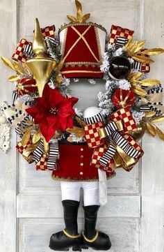 a wreath with red, white and gold decorations