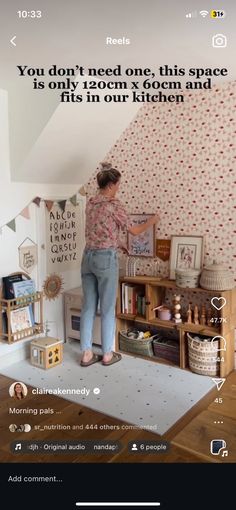 a woman standing on top of a rug in front of a wallpapered room