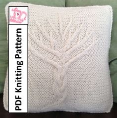 a white knitted pillow sitting on top of a green couch